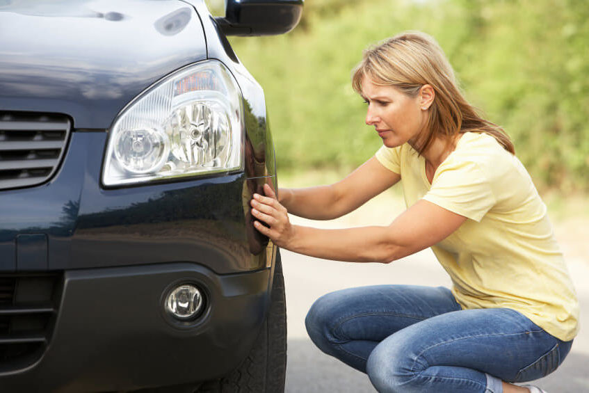 Woman changing tyre Durham
